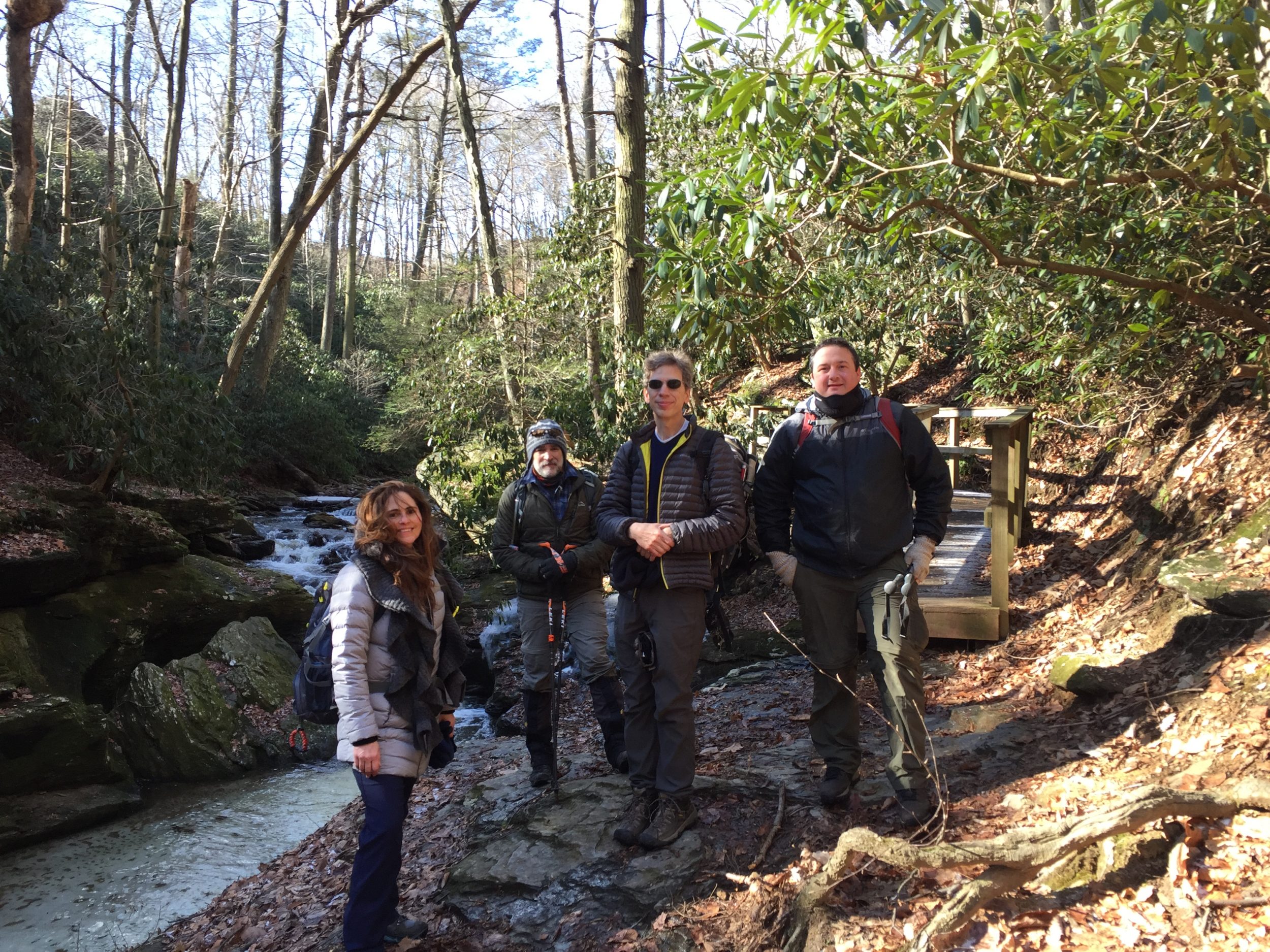 a group of hikers along a stream
