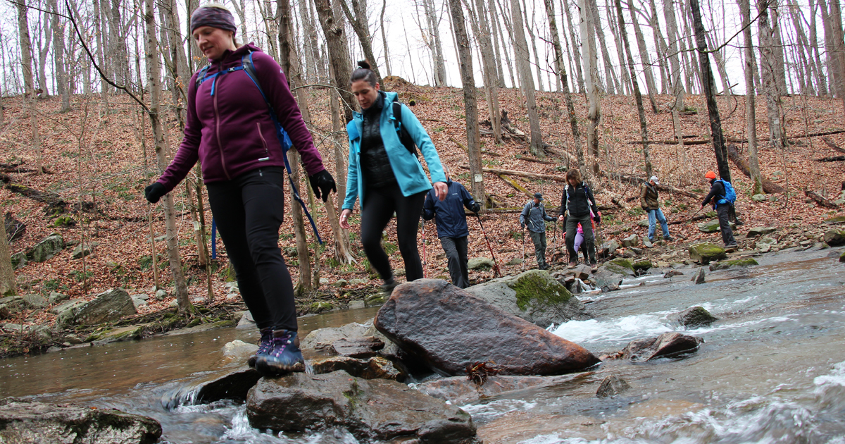 Hikers-cross-large-stream